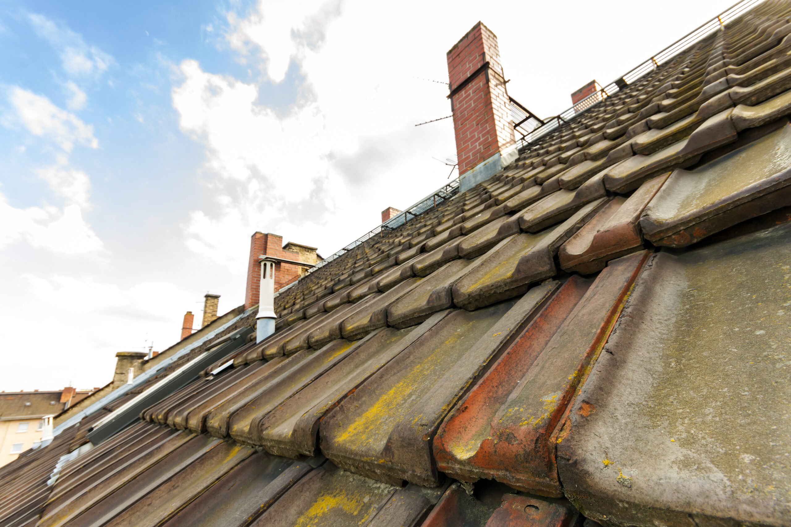 Old roof with roofing tiles and chimneys